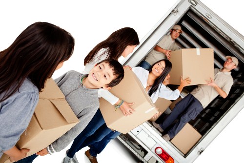 Students moving boxes into local storage in Watford